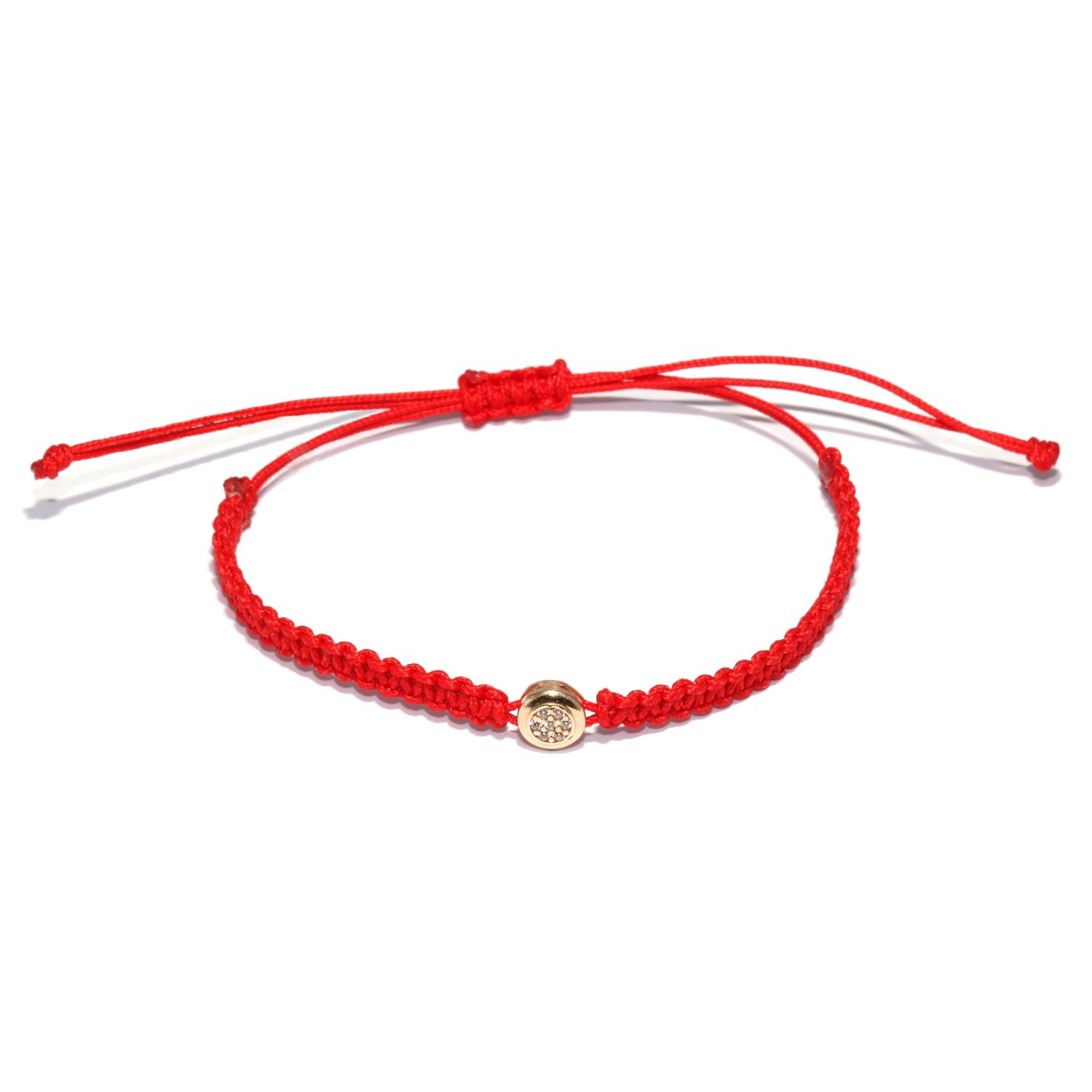 Red string bracelet with a gold charm